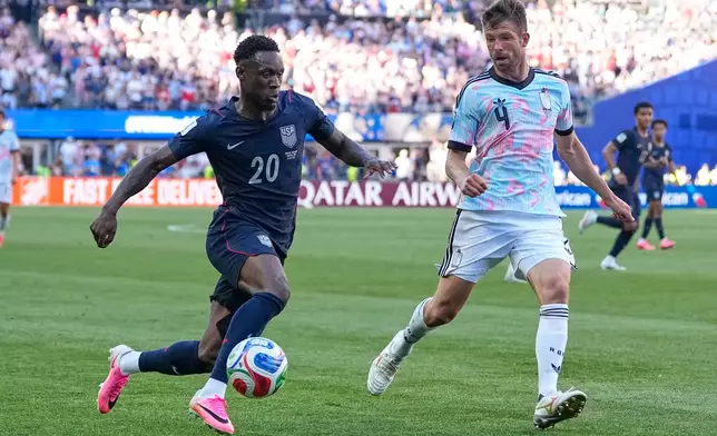 United States' Folarin Balogun (20) and Belgium's Brandon Mechele (4) battle for the ball during the World Cup round of 16 soccer match between the United States and Belgium in Seattle, Monday, July 6, 2026. (AP Photo/Lindsey Wasson)