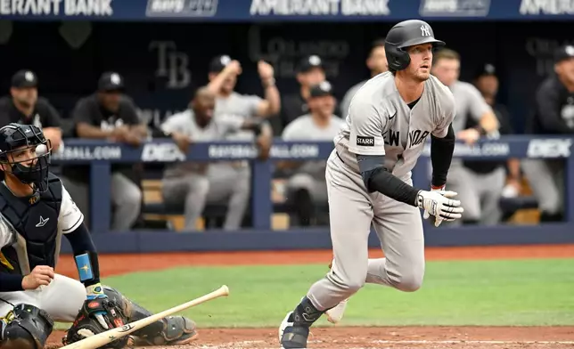Tampa Bay Rays catcher Nick Fortes watches as New York Yankees' Ryan McMahon hits an RBI double during the third inning of a baseball game Thursday, July 9, 2026, in St. Petersburg, Fla. (AP Photo/Jason Behnken)