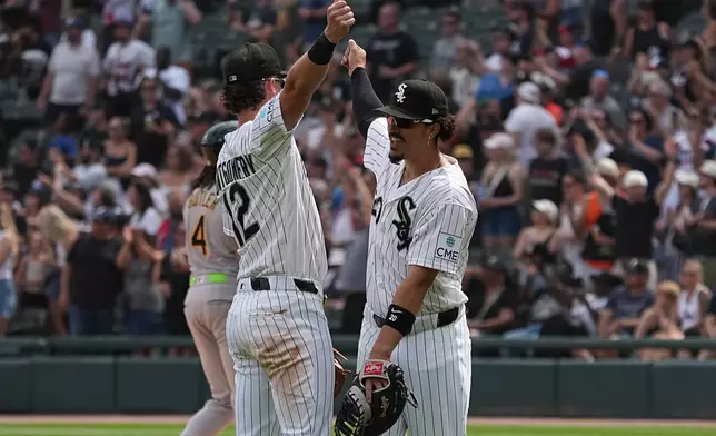 Chicago White Sox shortstop Colson Montgomery, left, and first baseman Miguel Vargas, right, celebrate their win against the Athletics in a baseball game Saturday, July 11, 2026, in Chicago. (AP Photo/David Banks)