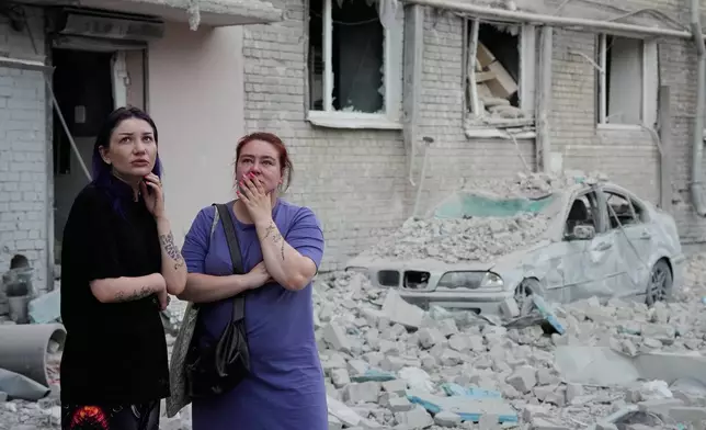 People react at the site of a Russian missile strike that hit a residential building in Kyiv, Ukraine, Thursday, July 2, 2026. (AP Photo/Efrem Lukatsky)