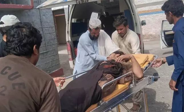 Rescue workers and volunteers transport an inured victim at a hospital after an overcrowded passenger bus plunged from a highway into a rocky ravine, in Dana Sar, a remote area near the border of Balochistan and Khyber Pakhtunkhwa provinces, in southwestern Pakistan, Friday, July 3, 2026. (AP Photo/Zain Ullah)