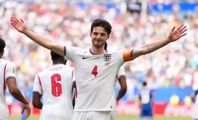 England's Declan Rice (4) celebrates scoring their first goal during the World Cup third-place playoff soccer match between France and England in Miami Gardens, Fla., Saturday, July 18, 2026. (AP Photo/Rebecca Blackwell)