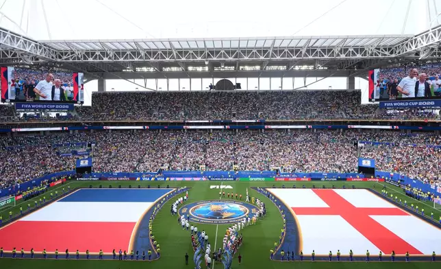 Teams march onto the pitch ahead of the World Cup third-place playoff soccer match between France and England in Miami Gardens, Fla., Saturday, July 18, 2026. (AP Photo/Marta Lavandier)