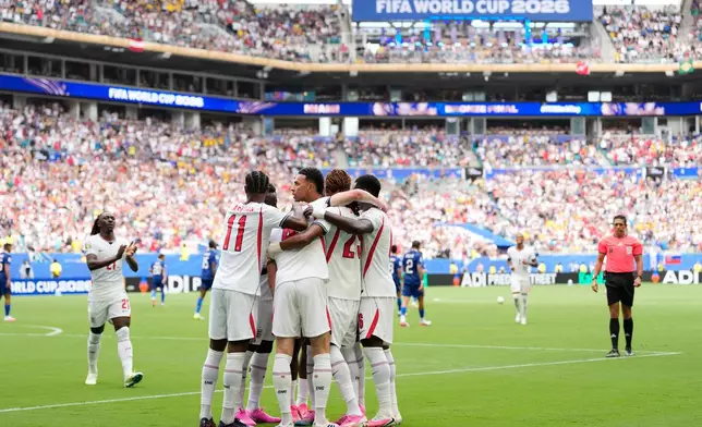 England's Marcus Rashford (11), England's Declan Rice, center, and others celebrate after Rice scored their side's first goal during the World Cup third-place playoff soccer match between France and England in Miami Gardens, Fla., Saturday, July 18, 2026. (AP Photo/Rebecca Blackwell)