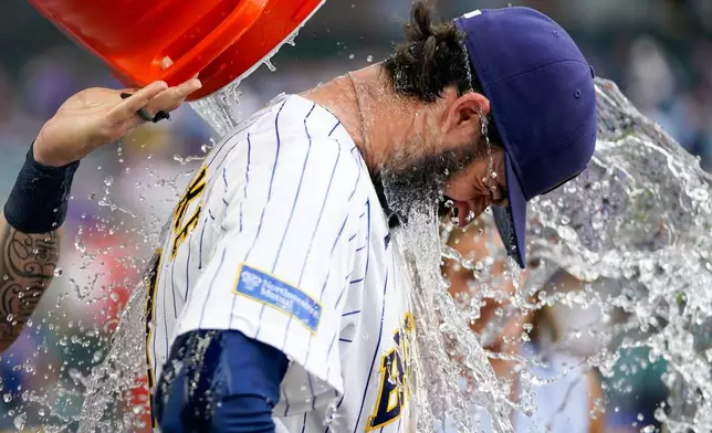 Milwaukee Brewers' Braden Shewmake is doused by Garrett Mitchell after winning a baseball game against the Miami Marlins Saturday, July 18, 2026, in Milwaukee. (AP Photo/Kayla Wolf)