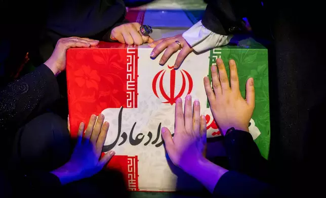 Mourners touch the coffin of Zahra Haddad-Adel, daughter of former Iranian parliament speaker Gholam-Ali Haddad-Adel and wife of Iran's Supreme Leader Mojtaba Khamenei, during her funeral in Tehran, Thursday, July 2, 2026. According to Iranian authorities she was killed in the same strike that killed then-Supreme Leader Ali Khamenei.(Fars News Agency via AP)(Fars News Agency via AP)