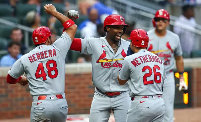 St. Louis Cardinals' Jordan Walker, center, reacts with Iván Herrera (48) and JJ Wetherholt (26) after hitting a three-run home run in the first inning of a baseball game against the Atlanta Braves, Thursday, July 2, 2026, in Atlanta. (AP Photo/Colin Hubbard)