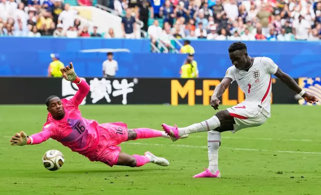 England's Bukayo Saka (7) shoots but does not score on a shot defended by France goalkeeper Mike Maignan (16) during the World Cup third-place playoff soccer match between France and England in Miami Gardens, Fla., Saturday, July 18, 2026. (AP Photo/Rebecca Blackwell)