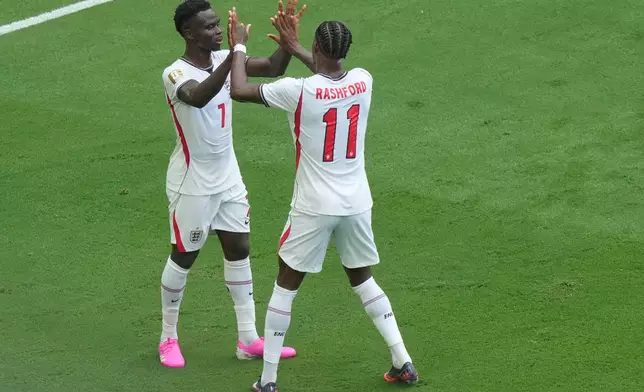 England's Bukayo Saka (7) celebrates scoring their fourth goal with Marcus Rashford (11) during the World Cup third-place playoff soccer match between France and England in Miami Gardens, Fla., Saturday, July 18, 2026. (AP Photo/Marta Lavandier)