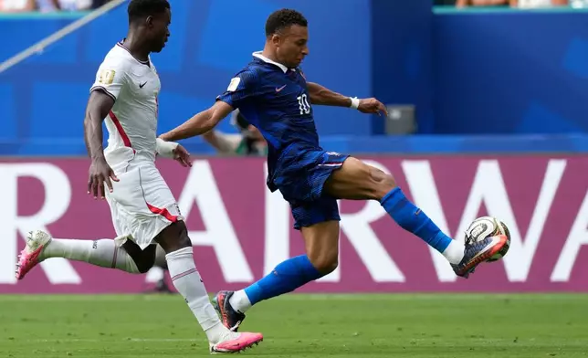 France's Kylian Mbappe, right, controls the ball past England's Marc Guehi (6) during the World Cup third-place playoff soccer match between France and England in Miami Gardens, Fla., Saturday, July 18, 2026. (AP Photo/Lynne Sladky)