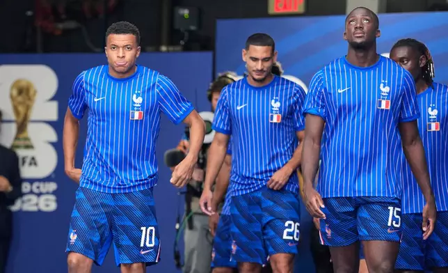 France's Kylian Mbappe (10), Maxence Lacroix (26) and Ibrahima Konate (15) walk onto the pitch for warmups before the World Cup third-place playoff soccer match between France and England in Miami Gardens, Fla., Saturday, July 18, 2026. (AP Photo/Rebecca Blackwell)