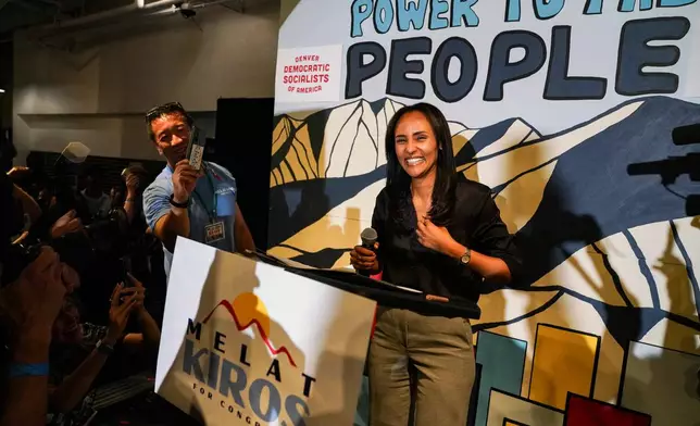 Democratic congressional candidate Melat Kiros stands on stage as supporters cheer after she won the Democratic nomination during a primary election night watch party at The Broadway, Tuesday, June 30, 2026, in Denver. (AP Photo/Rebecca Slezak)