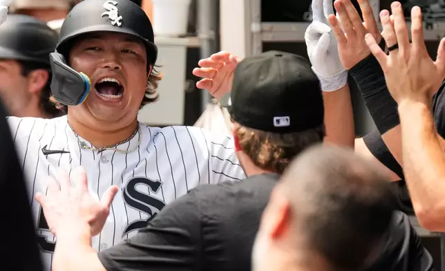 Chicago White Sox's Munetaka Murakami, left, of Japan, celebrates with teammates after hitting a two-run home run during the first inning of a baseball game against the Houston Astros in Chicago, Sunday, July 26, 2026. (AP Photo/Nam Y. Huh)