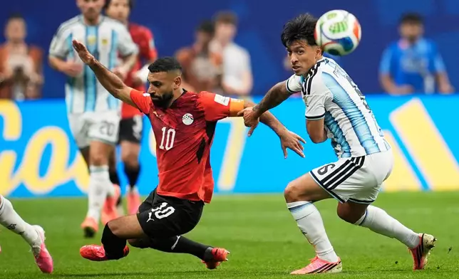 Egypt's Mohamed Salah (10) battles for the ball with Argentina's Lisandro Martinez (6) during the World Cup round of 16 soccer match between Argentina and Egypt in Atlanta, Tuesday, July 7, 2026. (AP Photo/Mike Stewart)