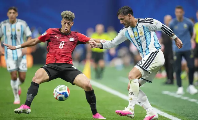 Argentina's Leandro Paredes (5) and Egypt's Emam Ashour (8) challenge for the ball during the World Cup round of 16 soccer match between Argentina and Egypt in Atlanta, Tuesday, July 7, 2026. (AP Photo/Jacob Kupferman)
