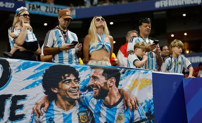 Argentinas fans display a banner depicting Leo Messi and Diego Armando Maradona, ahead of the World Cup round of 16 soccer match between Argentina and Egypt in Atlanta, Tuesday, July 7, 2026. (AP Photo/Erik S. Lesser)