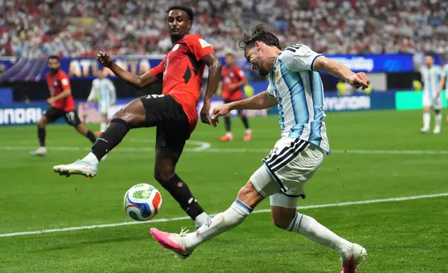 Egypt's Haissem Hassan (12) defends against Argentina's Nicolas Tagliafico (3) during the World Cup round of 16 soccer match between Argentina and Egypt in Atlanta, Tuesday, July 7, 2026. (AP Photo/Jacob Kupferman)