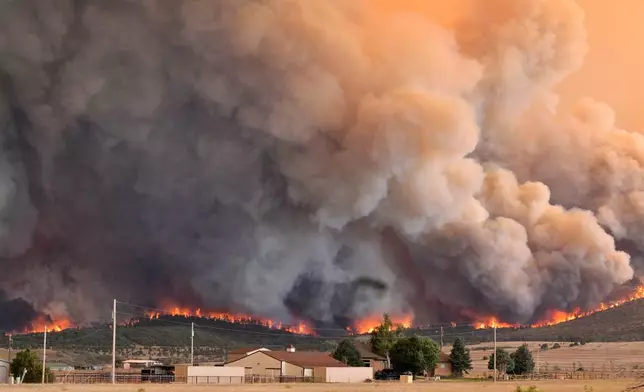 The Aspen Acres fire engulfs a hillside near Beulah, Colo., on Monday, June 29, 2026. (Jerilee Bennett/The Gazette via AP)