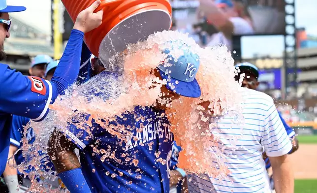 Kansas City Royals' Salvador Perez, center, is doused by teammates following a baseball game against the Detroit Tigers, Saturday, July 25, 2026, in Detroit. (AP Photo/Jose Juarez)