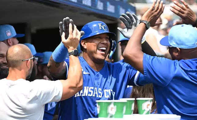 Kansas City Royals designated hitter Salvador Perez, center, is congratulated by teammates after hitting a home run during the seventh inning of a baseball game against the Detroit Tigers, Saturday, July 25, 2026, in Detroit. (AP Photo/Jose Juarez)