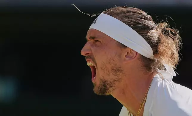 Alexander Zverev of Germany celebrates after winning the first set against Jannik Sinner of Italy during the men's singles final at Wimbledon Tennis Championships in London, Sunday, July 12, 2026. (AP Photo/Kin Cheung)