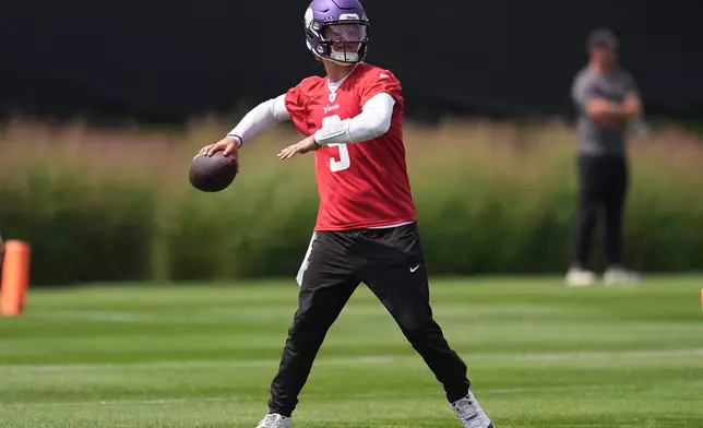Minnesota Vikings quarterback J.J. McCarthy (9) takes part in drills during the team's NFL football training camp Wednesday, July 29, 2026, in Eagan, Minn. (AP Photo/Abbie Parr)