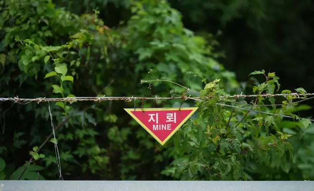 A sign indicating land mines is seen near the civilian control line in Cheorwon, South Korea, Thursday, July 16, 2026. (AP Photo/Lee Jin-man)