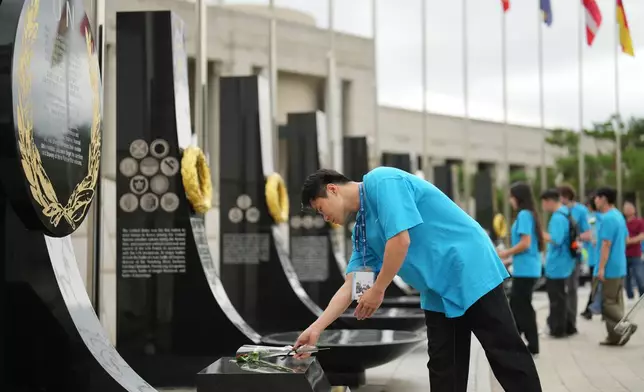 South Korean Jo Suk-hyun places flower at Korean War veterans memorial in Seoul, South Korea, Sunday, July 5, 2026. (AP Photo/Lee Jin-man)