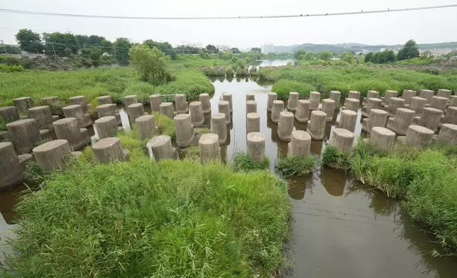 Anti-tank barriers are placed in a stream in Goyang, South Korea, Thursday, July 2, 2026. (AP Photo/Lee Jin-man)