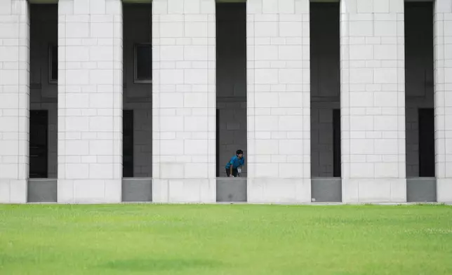 South Korean student Min Woo-jin looks at monuments with the names of soldiers killed during the 1950-53 Korean War, at the War Memorial of Korea in Seoul, South Korea, Sunday, July 5, 2026. (AP Photo/Lee Jin-man)
