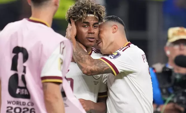Spain's Pedro Porro, right, and Spain's Lamine Yamal celebrate after the World Cup semifinal soccer match between France and Spain in Arlington, Texas, near Dallas, Tuesday, July 14, 2026. (AP Photo/Abbie Parr)
