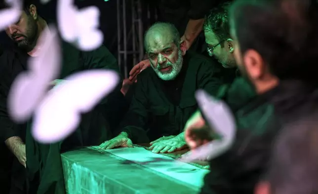 In this photo released by Iran's Supreme Leader's office, Iran's paramilitary Revolutionary Guard Gen. Ahmad Vahidi sits alongside Iran's Supreme Leader Ayatollah Ali Khamenei casket as it lies in a mourning hall adjacent to the Imam Khomeini Hussainiya within the Supreme Leader's compound before his funeral in Tehran, Iran, late Thursday, July 2, 2026. (Office of the Iranian Supreme Leader via AP)