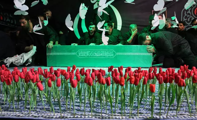 In this photo released by Iran's Supreme Leader's office, mourners gather around the coffin of Iran's Supreme Leader Ayatollah Ali Khamenei as it lies in a mourning hall adjacent to the Imam Khomeini Hussainiya within the Supreme Leader's compound before his funeral in Tehran, Iran, late Thursday, July 2, 2026. (Office of the Iranian Supreme Leader via AP)