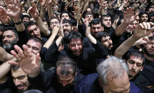 In this photo released by Iran's Supreme Leader's office, mourners react as they gather around the coffin of Iran's Supreme Leader Ayatollah Ali Khamenei as it lies in a mourning hall adjacent to the Imam Khomeini Hussainiya within the Supreme Leader's compound before his funeral in Tehran, Iran, late Thursday, July 2, 2026. (Office of the Iranian Supreme Leader via AP)