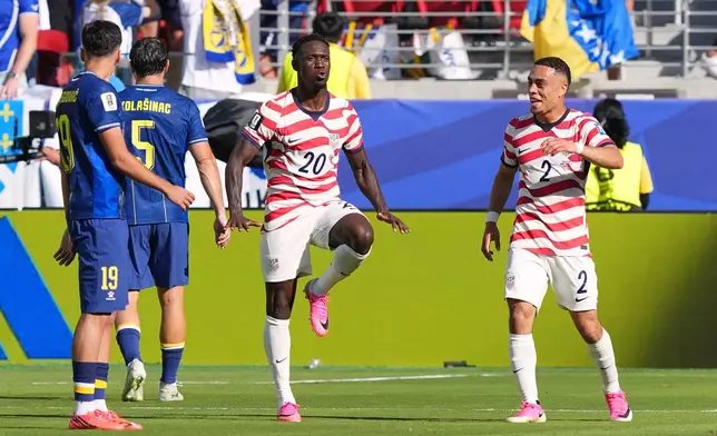 United States' Folarin Balogun (20) celebrates with United States' Sergino Dest (2) as Bosnia's Kerim Alajbegovic (19) and Bosnia's Sead Kolasinac (5) stand by after scoring during the World Cup round of 32 soccer match between the United States and Bosnia in Santa Clara, Calif., near San Francisco, Wednesday, July 1, 2026. (AP Photo/Martin Meissner)