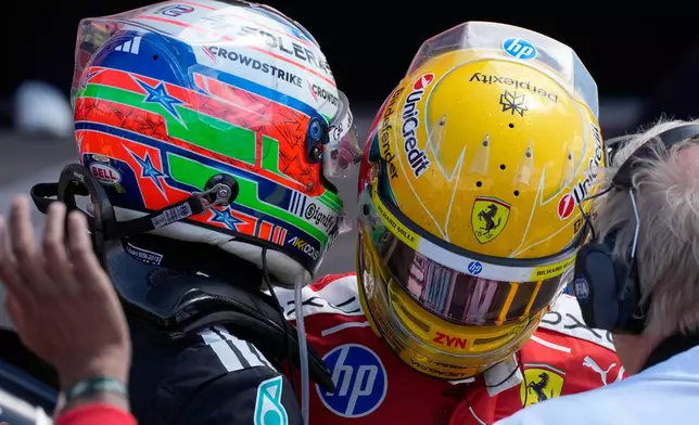 Mercedes driver Andrea Kimi Antonelli of Italy, left, speaks with second placed Ferrari driver Lewis Hamilton of Britain after winning the sprint race ahead of the British F1 Grand Prix, in Silverstone, England, Saturday, July 4, 2026. (AP Photo/Darko Bandic)