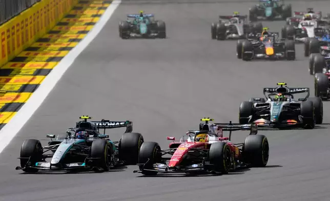 Ferrari driver Lewis Hamilton of Britain steers his car followed by Mercedes driver Andrea Kimi Antonelli of Italy and McLaren driver Lando Norris of Britain during the sprint race at the British F1 Grand Prix, in Silverstone, England, Saturday, July 4, 2026. (AP Photo/Darko Bandic)