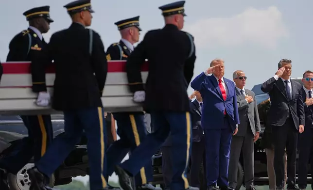 President Donald Trump and Secretary of Defense Pete Hegseth, salute as a U.S. Army carry team moves a transfer case containing the remains of Pvt. Isabella Gonzales of Carrollton, Texas, Wednesday, July 22, 2026, at Dover Air Force Base, Del. (AP Photo/Matt Rourke)