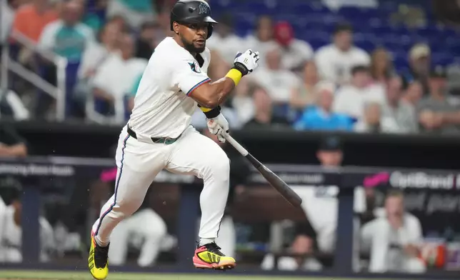 Miami Marlins' Otto Lopez runs to reach on a fielding error by Philadelphia Phillies first baseman Alec Bohm during the third inning of a baseball game, Tuesday, July 28, 2026, in Miami. (AP Photo/Lynne Sladky)