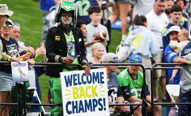 Fans watch the Seattle Seahawks practice during the NFL football team's training camp, Saturday, July 25, 2026, in Renton, Wash. (AP Photo/Lindsey Wasson)