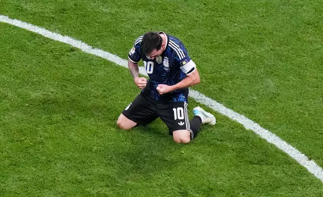 Argentina's Lionel Messi (10) kneels on the pitch as he celebrates defeating England in their World Cup semifinal soccer match in Atlanta, Wednesday, July 15, 2026. (AP Photo/Lynne Sladky)