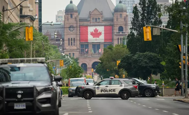 Police work the scene of an early morning shooting outside the US Consulate in Toronto, on Monday, July 27, 2026. (Sammy Kogan/The Canadian Press via AP)