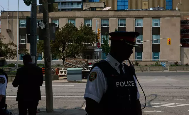 Police leave after speaking to media after a shot was fired at the U.S. Consulate in Toronto, on Monday, July 27, 2026. (Sammy Kogan/The Canadian Press via AP)