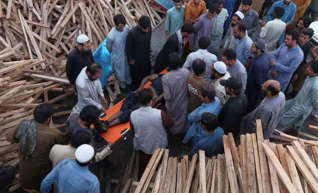 People transport the body of a miner recovered after an explosion inside a coal mine on the outskirts of Quetta, in southwest Pakistan, Thursday, July 30, 2026. (AP Photo/Fazal Tawab)