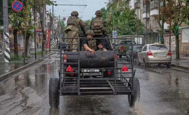 In this photo provided by Ukraine's 93rd Kholodnyi Yar Separate Mechanized Brigade press service, Ukrainian servicemen patrol a street in the frontline town of Druzhkivka, Donetsk region, Ukraine Friday, July 10, 2026. (Iryna Rybakova/Ukraine's 93rd Mechanized Brigade via AP)