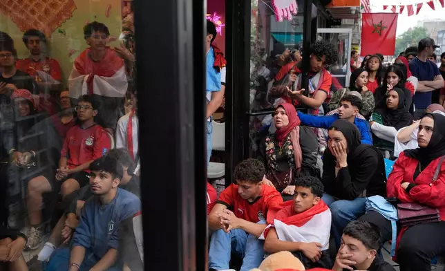 Egyptian soccer fans react as they watch the end of a World Cup soccer game between Egypt and Argentina, in New York, Tuesday, July 7, 2026. (AP Photo/Seth Wenig)