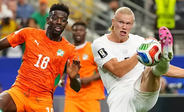 Norway's Erling Haaland (9), right, gets the ball past Ivory Coast's Ibrahim Sangare (18) during the World Cup round of 32 soccer match between Ivory Coast and Norway in Arlington, Texas, near Dallas, Tuesday, June 30, 2026. (AP Photo/Julio Cortez)