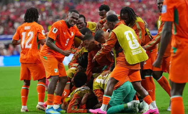 Ivory Coast's Amad Diallo (15) celebrates with teammates after scoring his side's opening goal during the World Cup round of 32 soccer match between Ivory Coast and Norway in Arlington, Texas, near Dallas, Tuesday, June 30, 2026. (AP Photo/Julio Cortez)