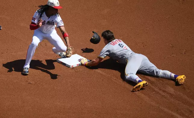 Pittsburgh Pirates' Konnor Griffin (6) steals second base against Washington Nationals shortstop CJ Abrams, left, during the first inning of a baseball game, Saturday, July 4, 2026, in Washington. (AP Photo/Nick Wass)