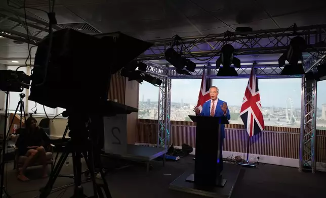 Reform UK leader Nigel Farage makes a statement to the media at the party headquarters in Millbank, central London, Tuesday July 7, 2026. (Gareth Fuller/PA via AP)